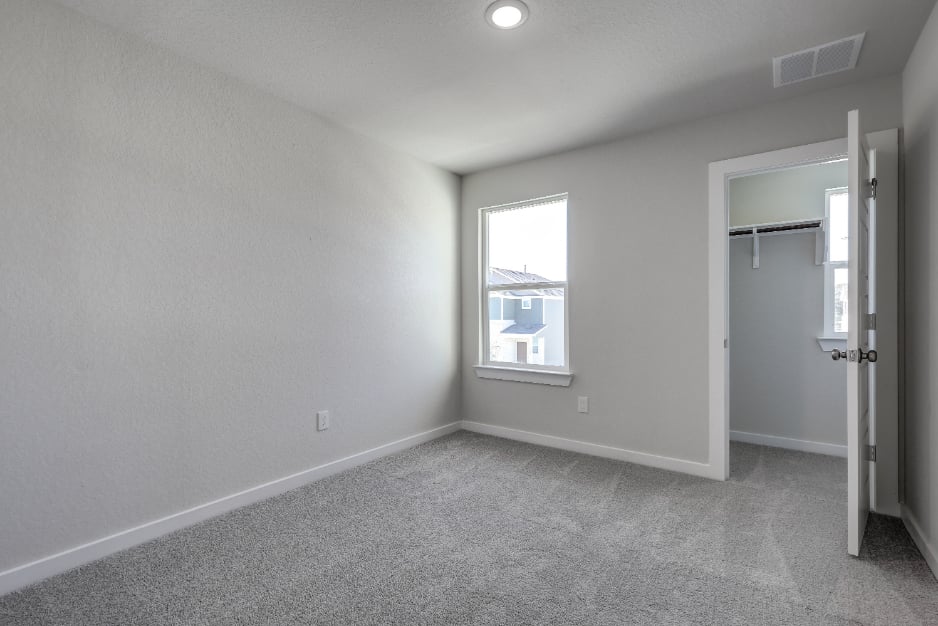 A room with a window and a door.