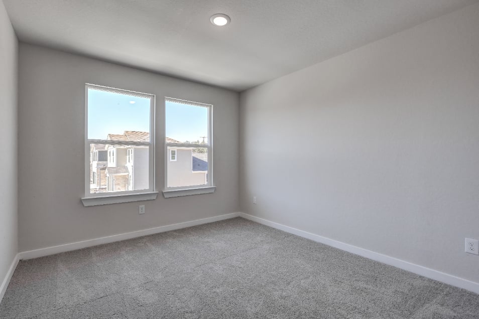 A room with a window and a carpet.