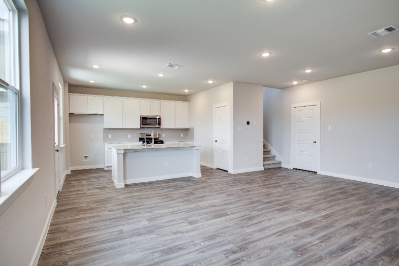 A large kitchen with white cabinets.