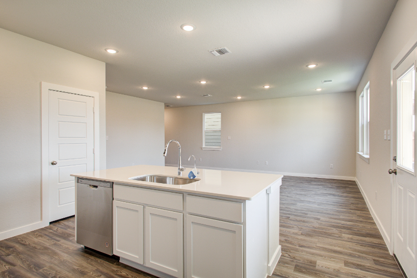 A kitchen with white cabinets.
