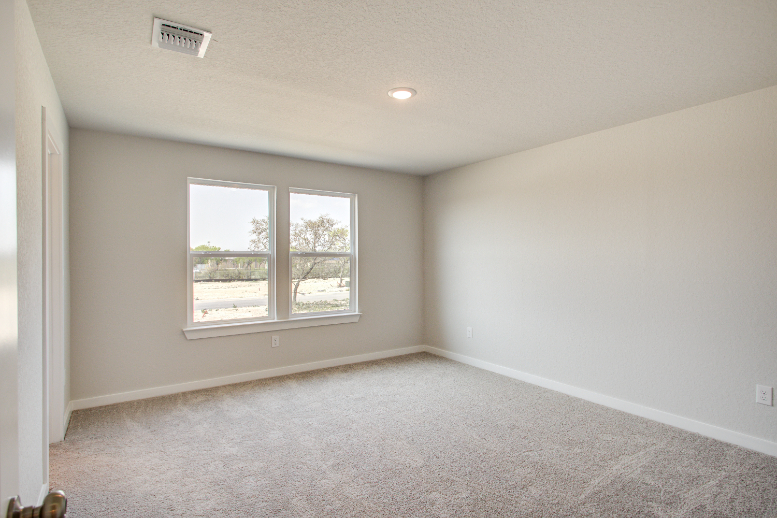 A room with a window and a carpet.