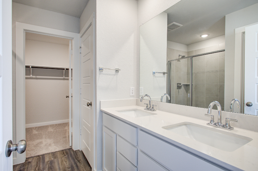 A bathroom with a large mirror.