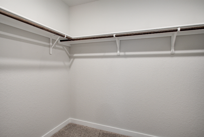 A white wall with a metal railing.