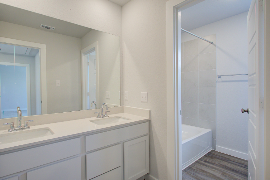 A bathroom with a shower and sink.
