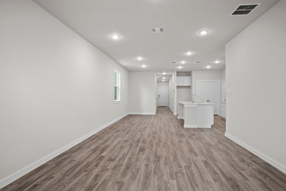 A long hallway with white walls.