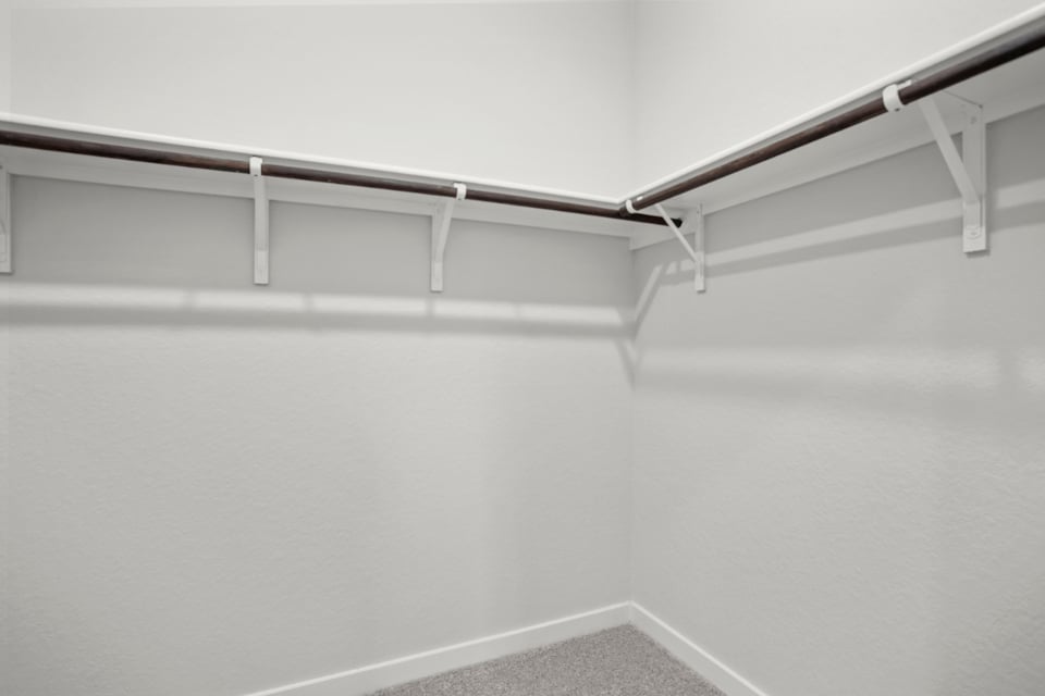 A white wall with a metal railing.