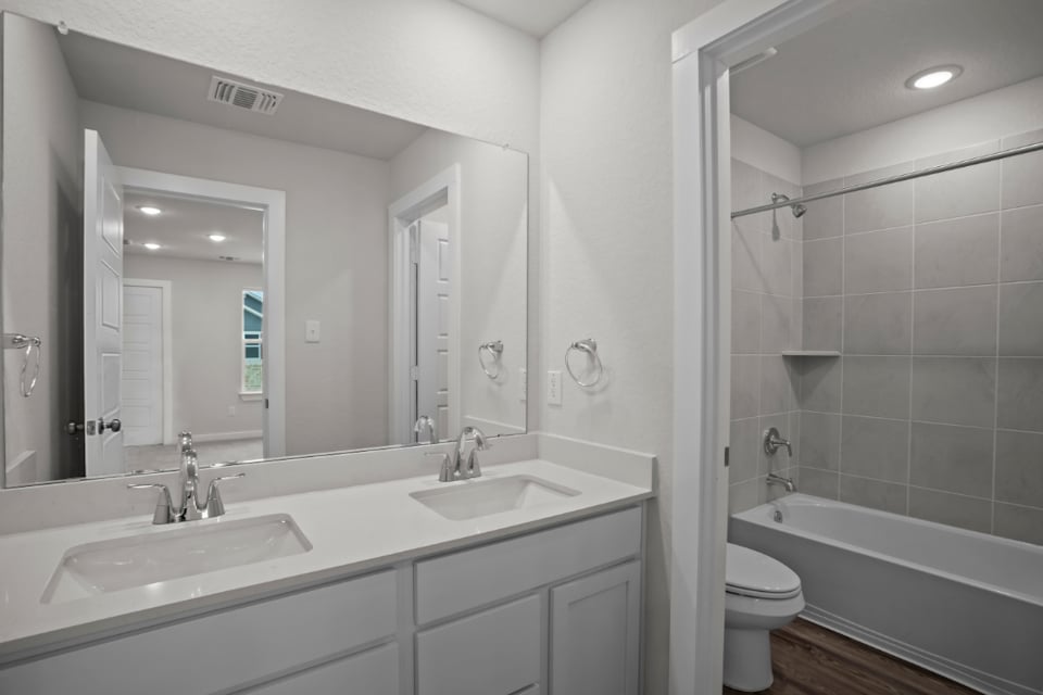 A bathroom with a tub sink and toilet.