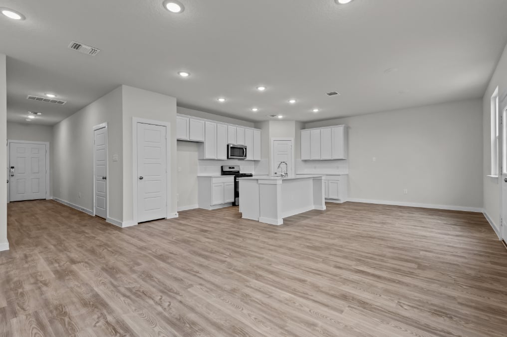 A large kitchen with white cabinets.