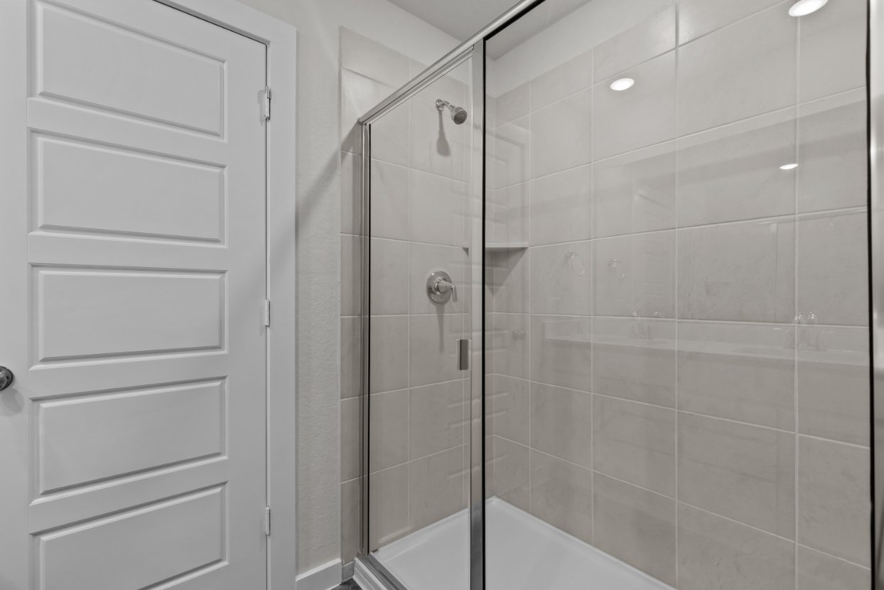 A shower with a glass door.