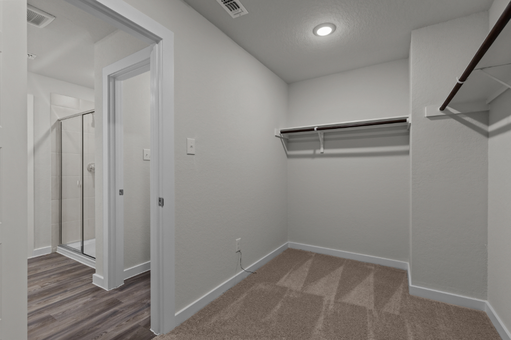 A room with a shower and a glass door.