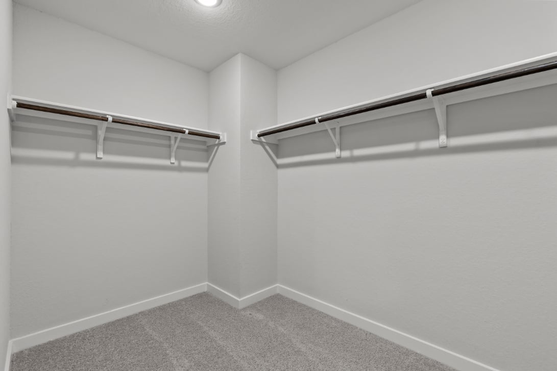 A white wall with a metal railing.