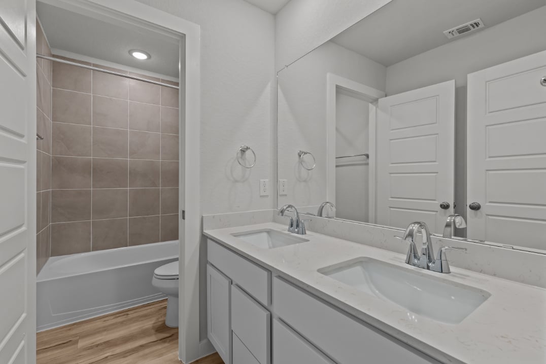 A bathroom with a tub sink and toilet.