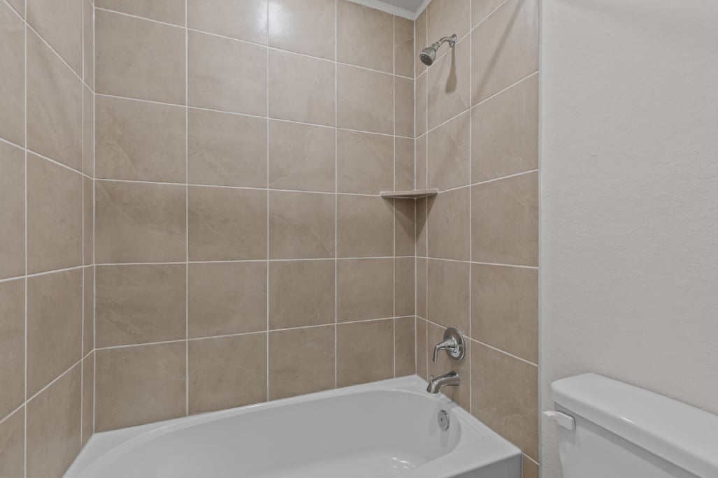 A bathtub in a bathroom.