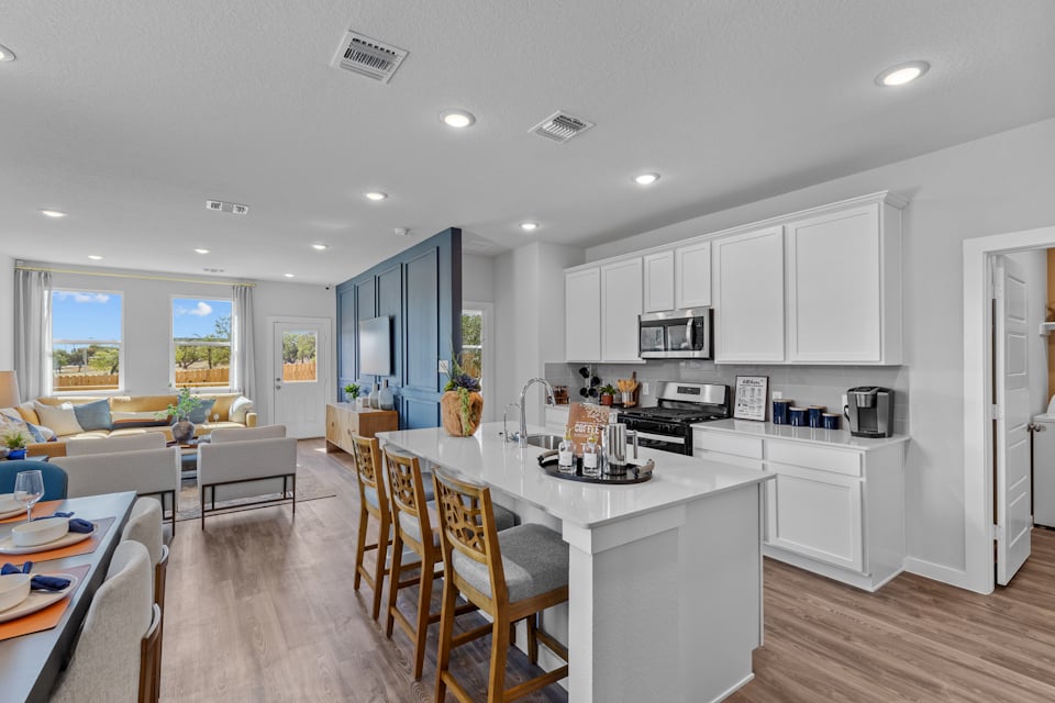 A kitchen with white cabinets.