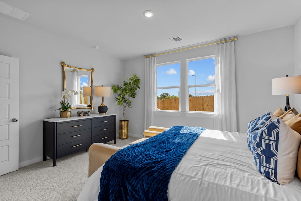 A bedroom with a bed and a window.
