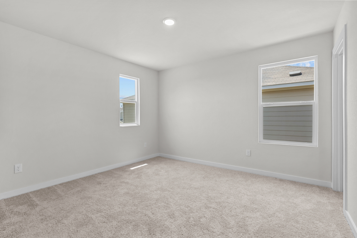 A room with a window and a carpet.