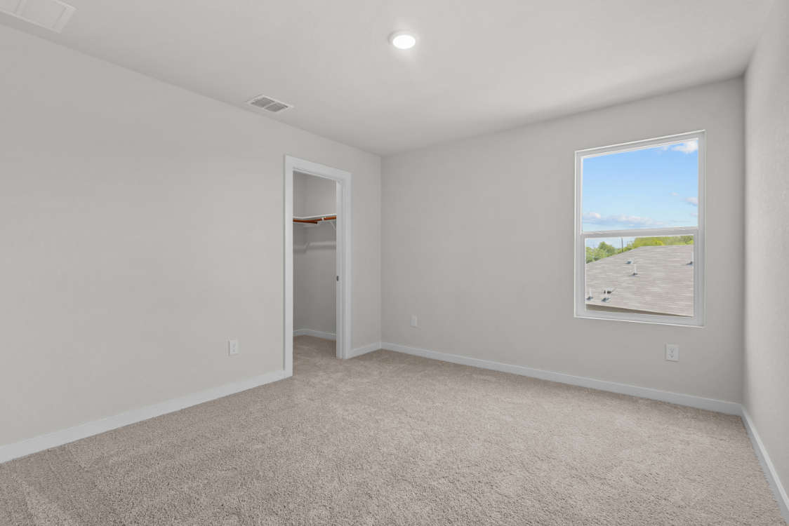 A room with a window and a door.