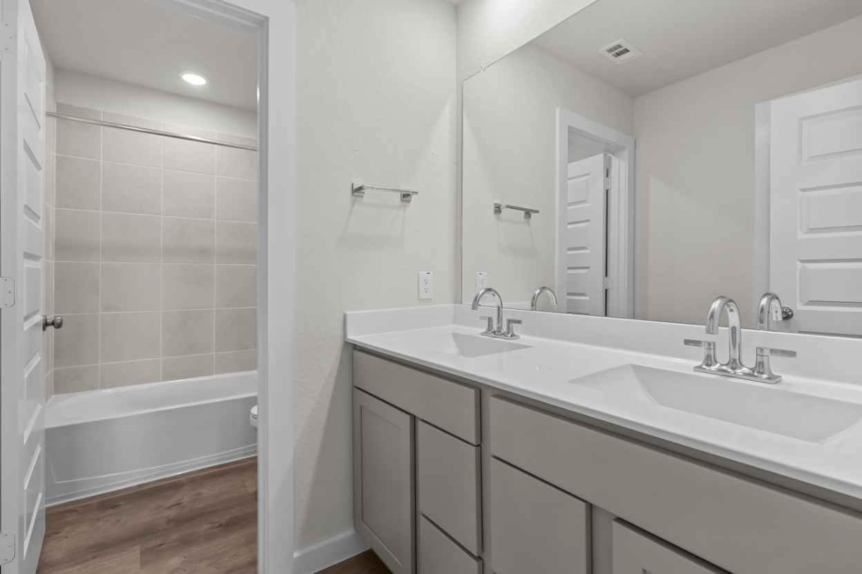 A bathroom with a tub sink and a shower.