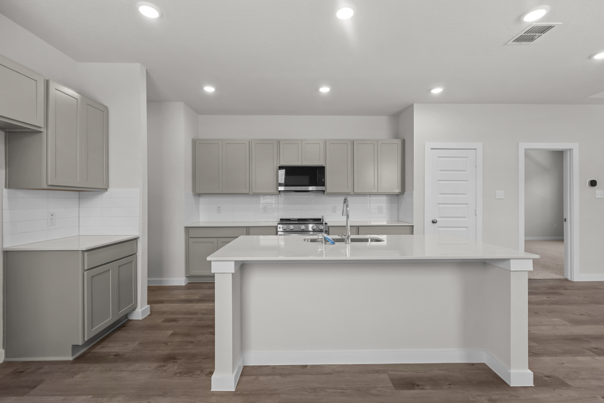 A kitchen with white cabinets.