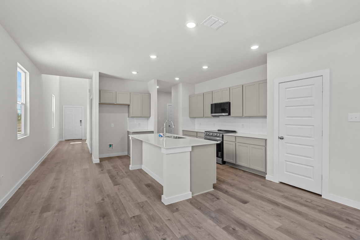 A kitchen with white cabinets.