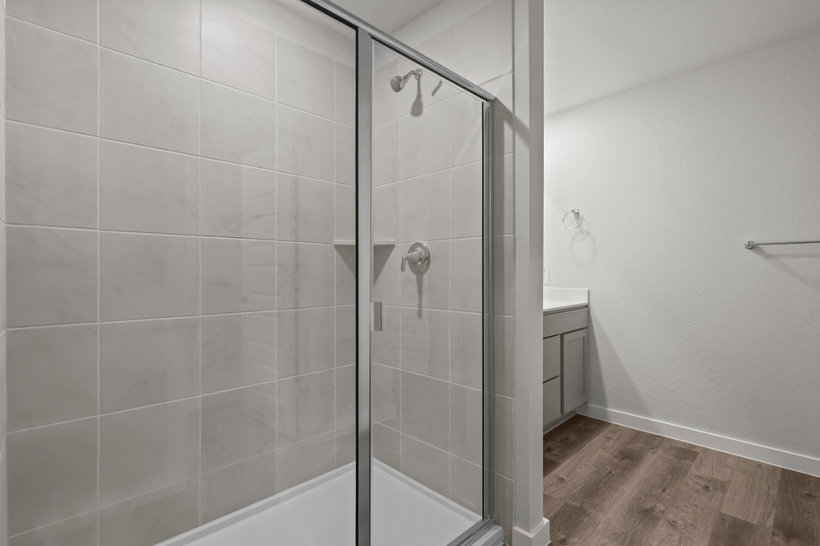 A shower with a glass door.