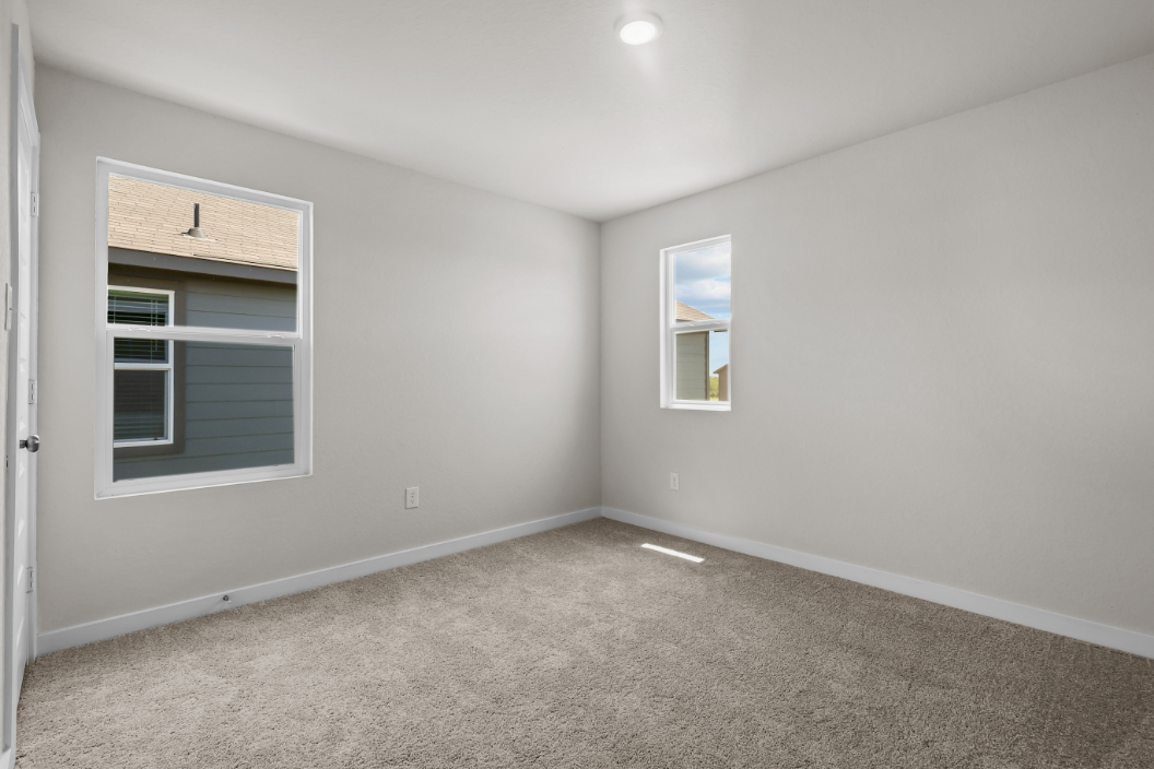 A room with a window and a carpet.