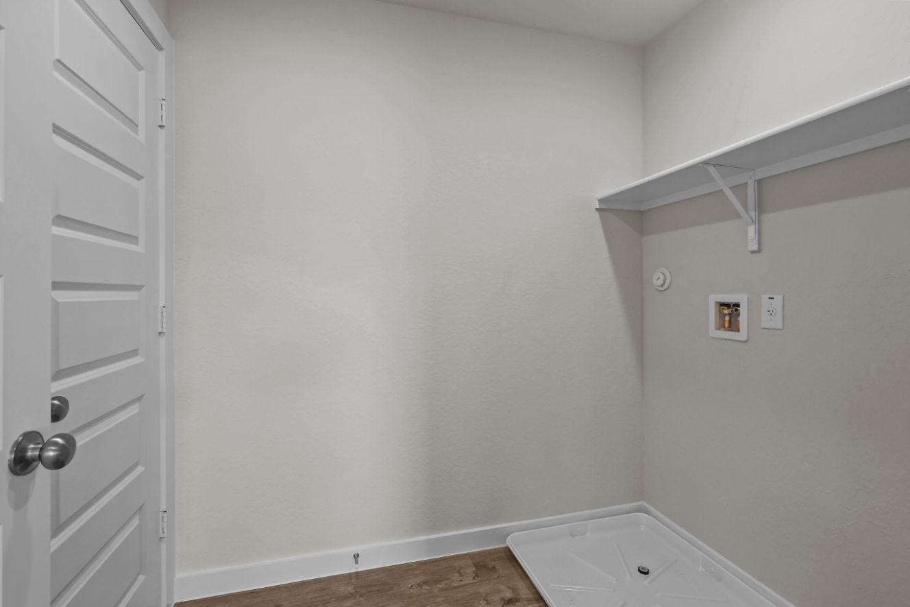 A white bathroom with a white door.
