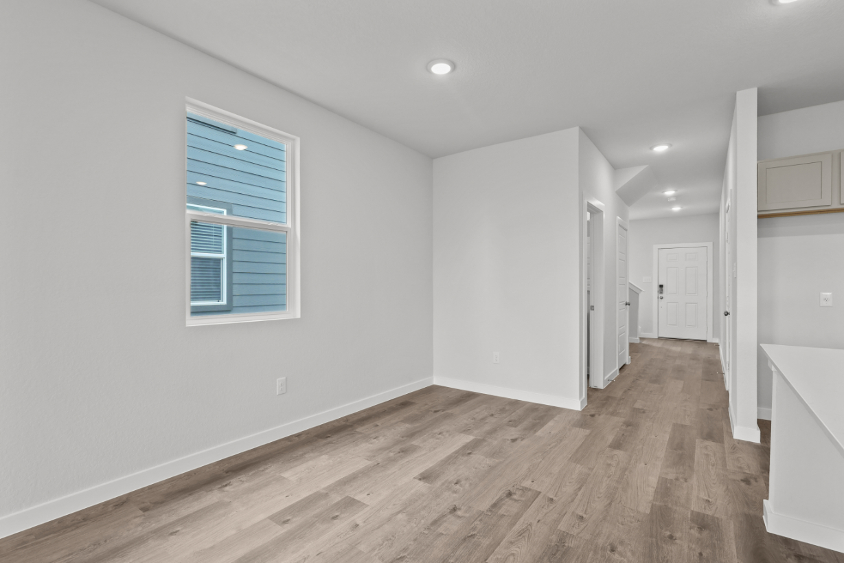 A room with white walls and a wood floor.