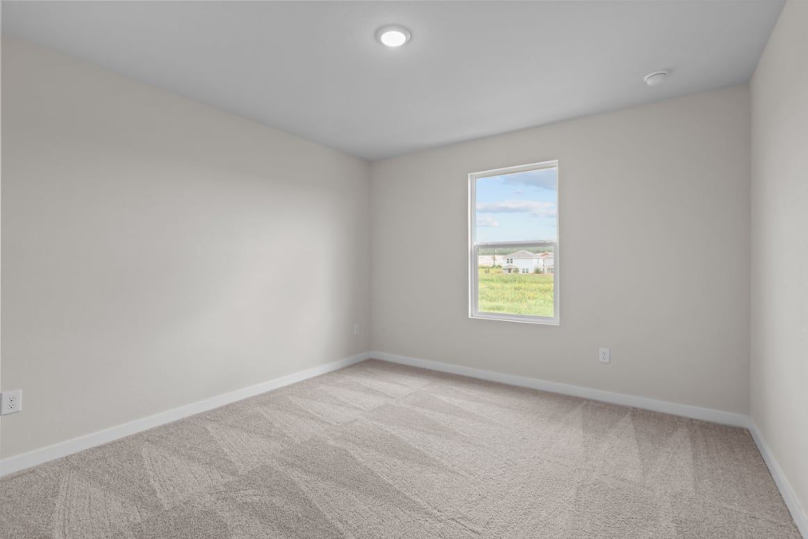 A room with a window and carpet.