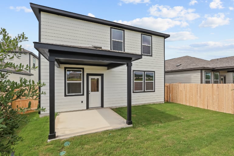 A house with a fence and grass.