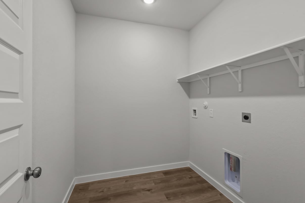 A white room with a wood floor.