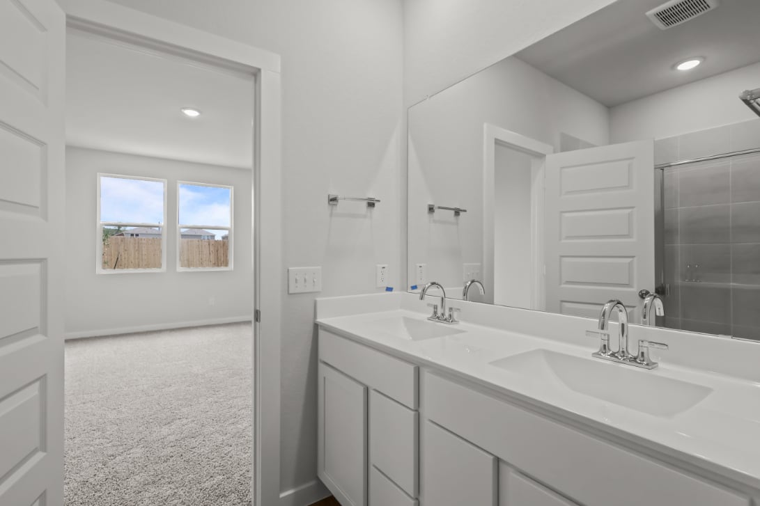 A bathroom with a large mirror.