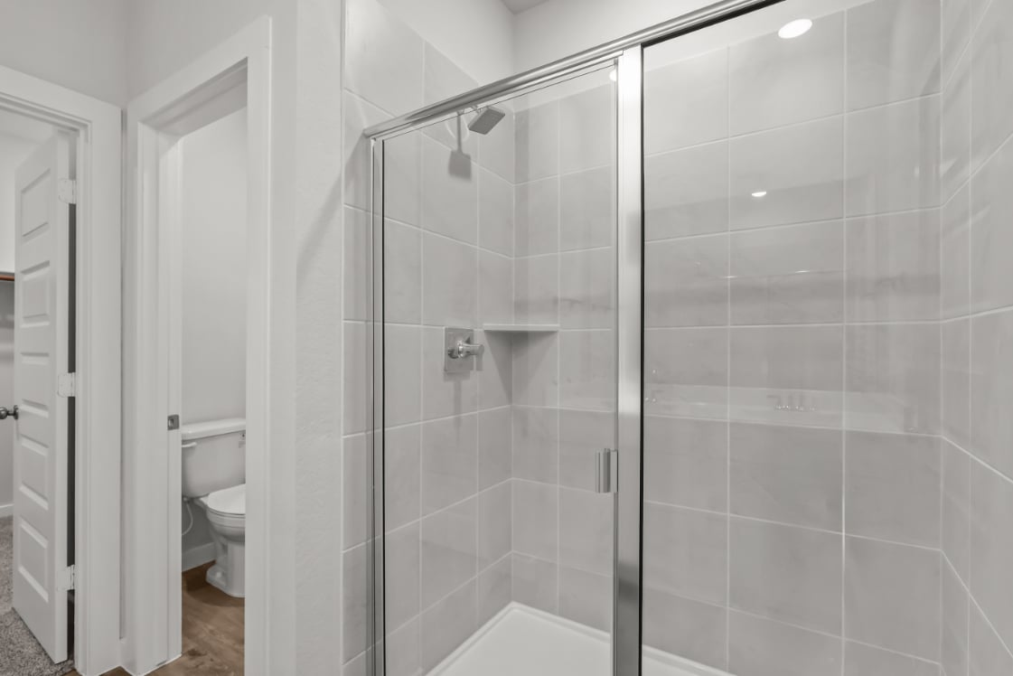 A shower with a glass door.