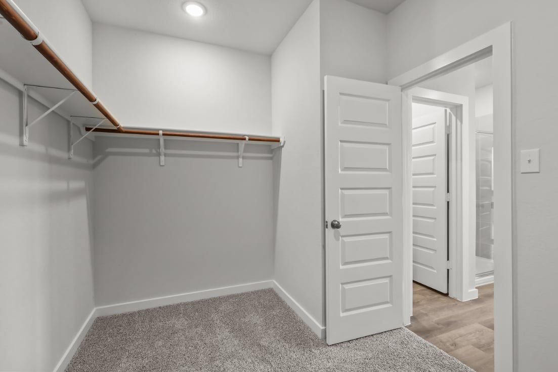 A white hallway with white doors.