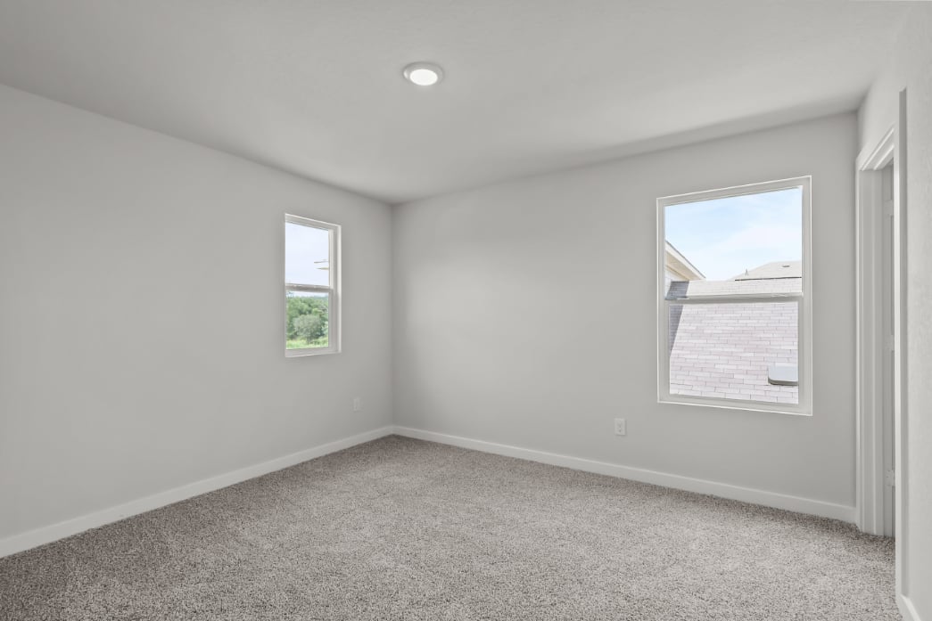A room with a window and a carpet.