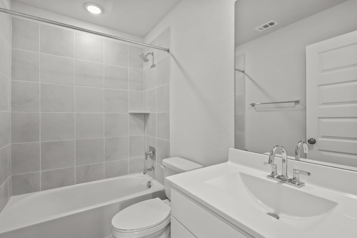 A bathroom with a sink toilet and bathtub.