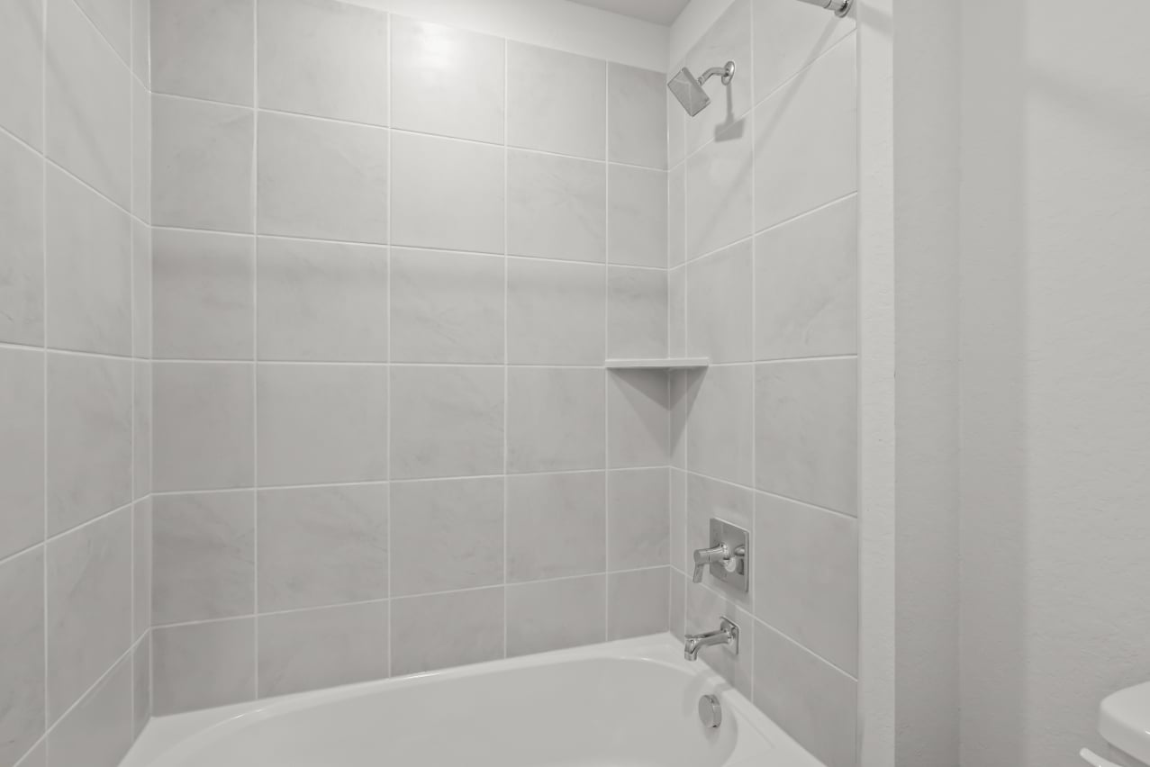 A bathroom with a bathtub and toilet.