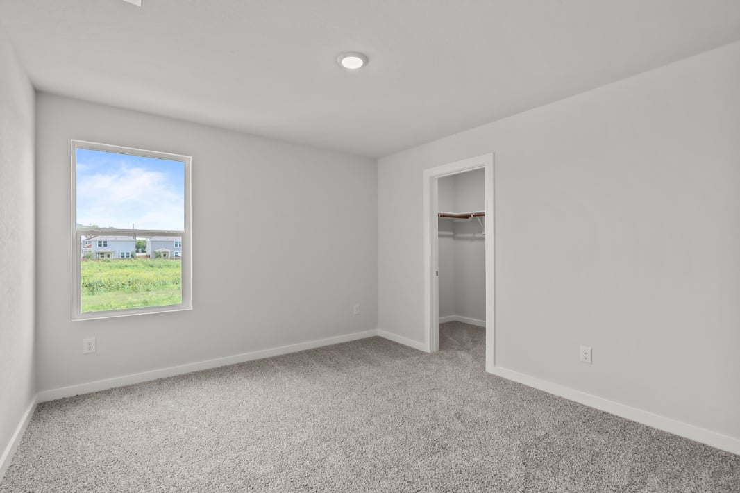 A room with a window and a door.