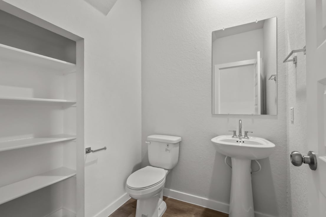 A bathroom with a toilet and sink.