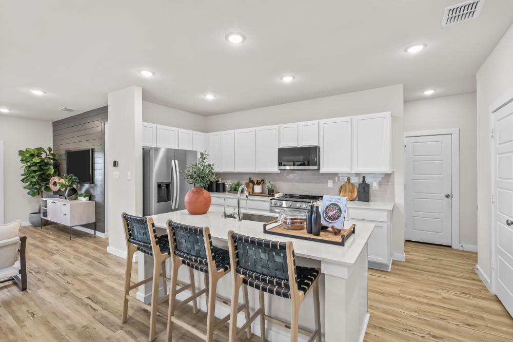 A kitchen with white cabinets.