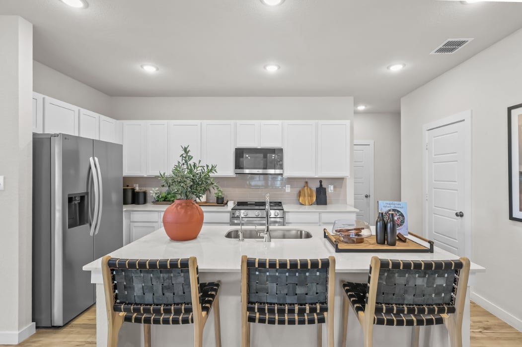 A kitchen with white cabinets.