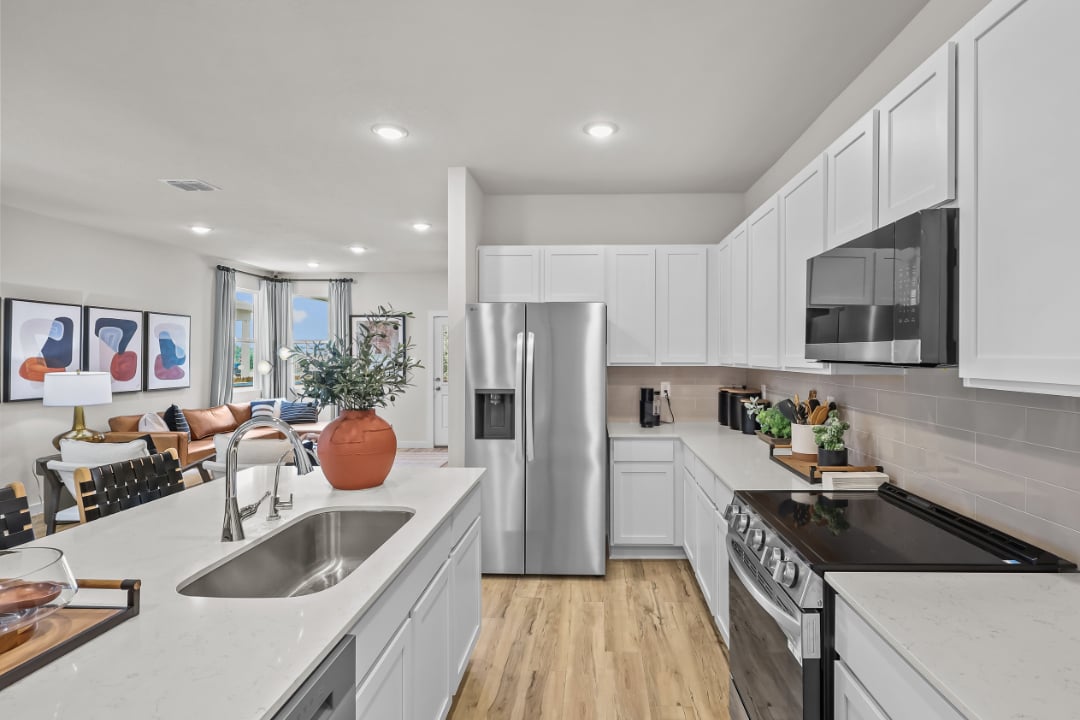 A kitchen with white cabinets.