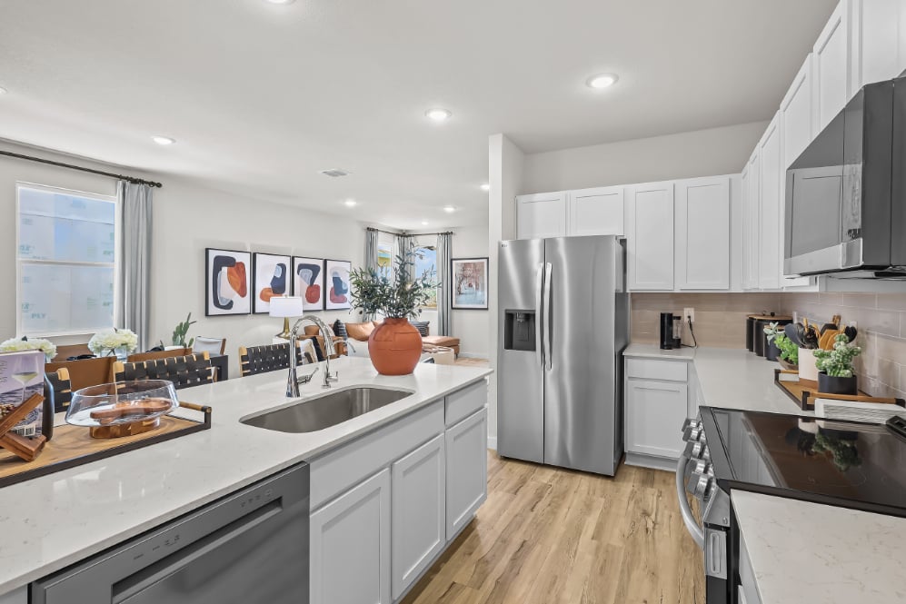 A kitchen with white cabinets.