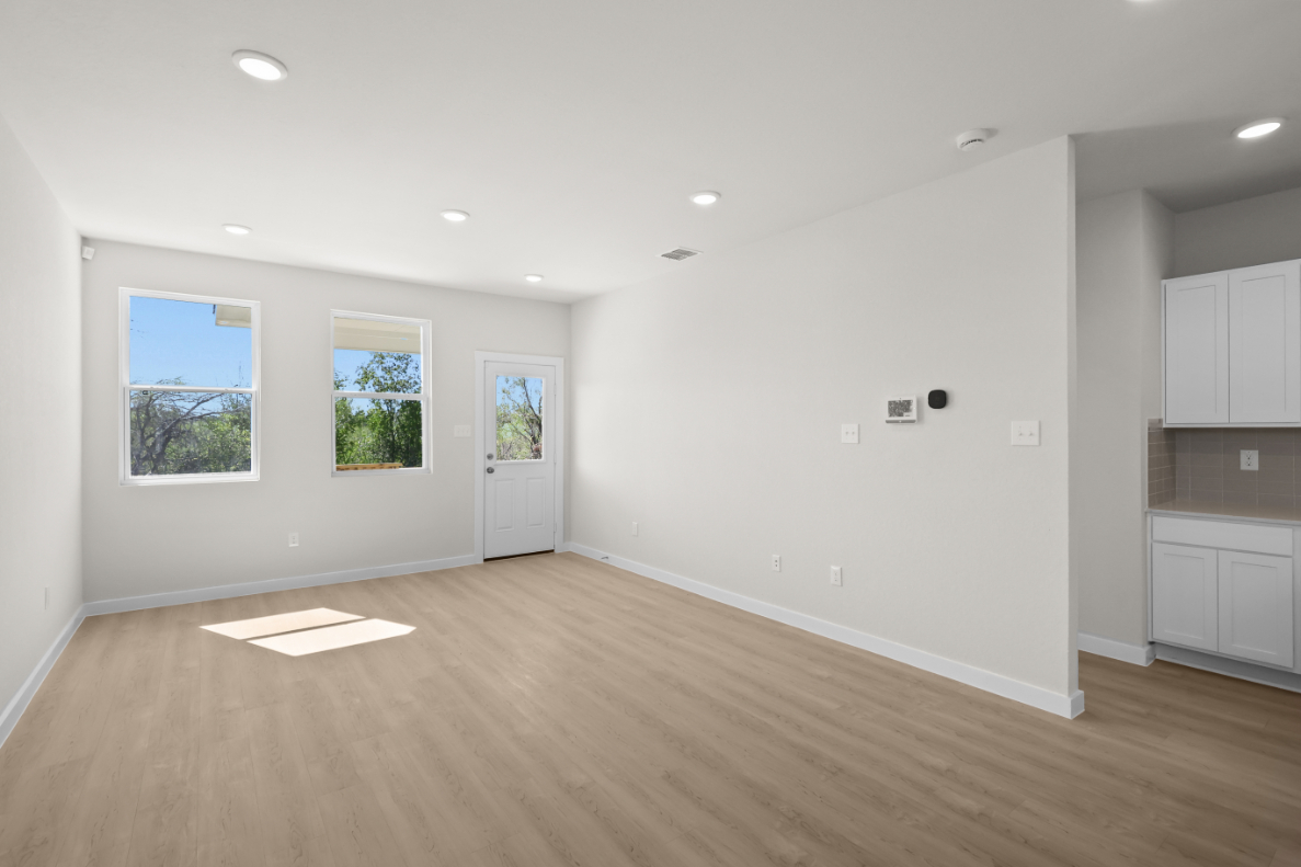 A room with white walls and a wood floor.