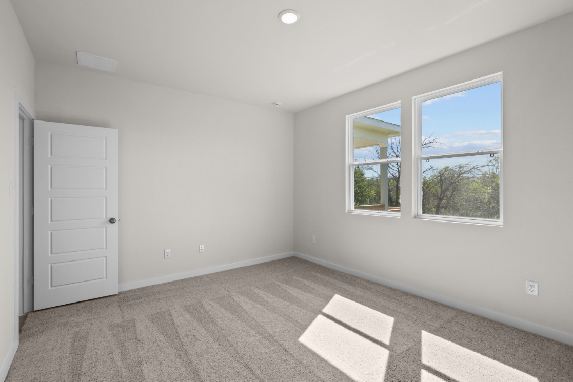 A room with a window and a rug in it.