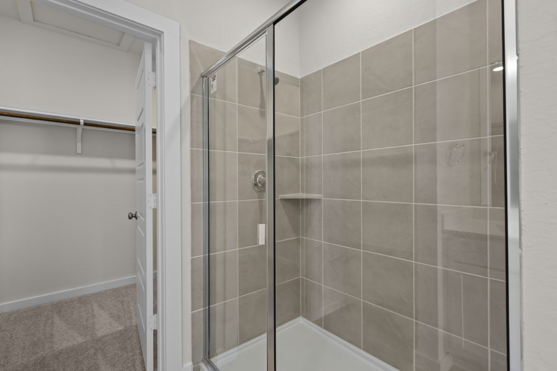 A shower with a glass door.