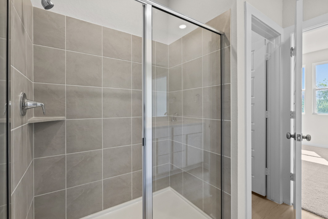 A shower with a glass door.