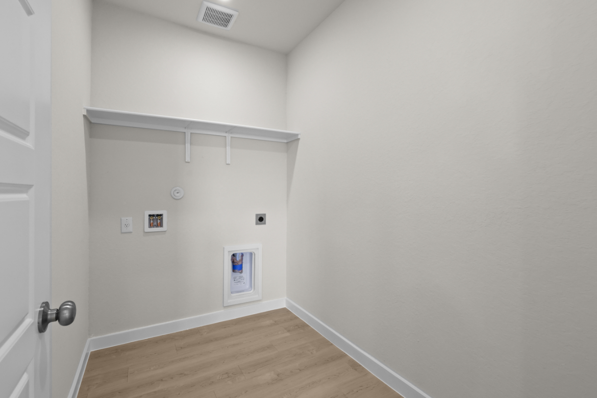 A white room with a wood floor.