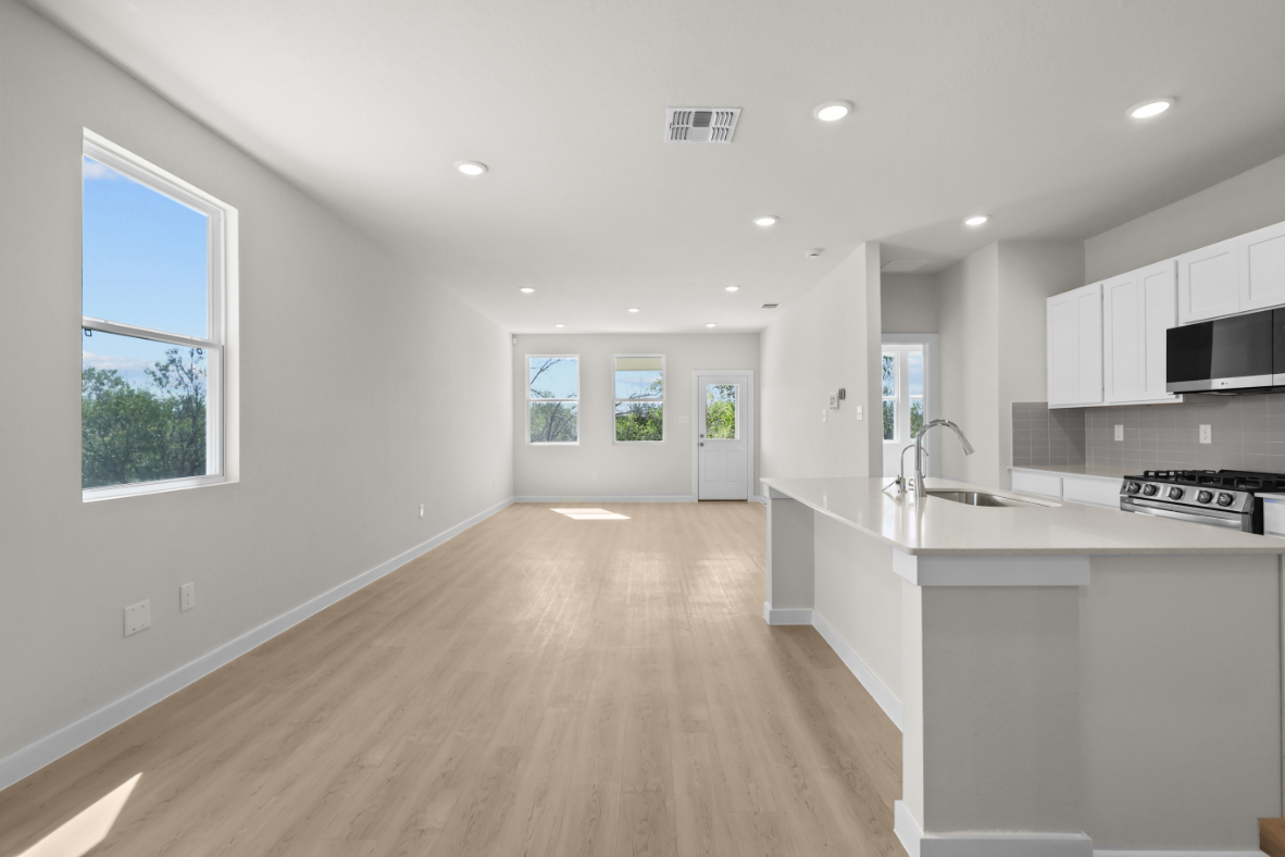 A kitchen with white cabinets.