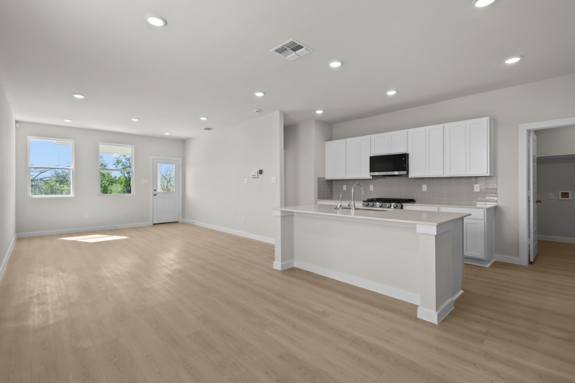 A large kitchen with white cabinets.